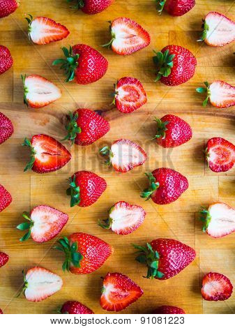 Arranged Pattern Of Strawberries On A Wooden Board