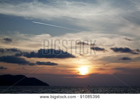 Airplane Contrail Against Sunset Sky