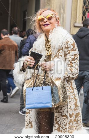 MILAN ITALY - FEBRUARY 25: Fashionable woman poses outside Luisa Beccaria fashion show building for Milan Women's Fashion Week on FEBRUARY 25 2016 in Milan.