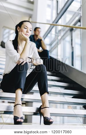 Business People Sitting On Stairs