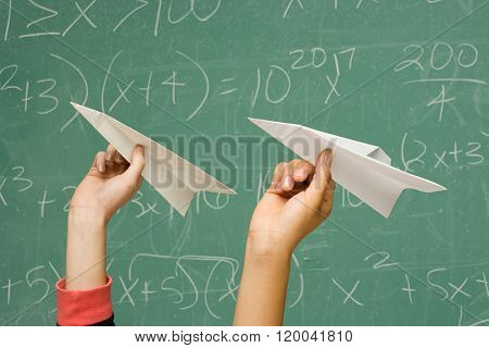 Two students about to throw paper aeroplanes