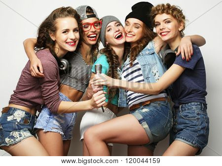 beautiful stylish hipster  girls singing karaoke 