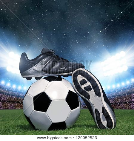 Soccer ball and shoes in grass