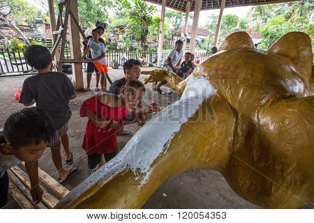 BALI, INDONESIA - MAR 1, 2016: Unidentified local people during built Ogoh-ogoh are statues for the Ngrupuk parade, which takes place on the eve of Nyepi day. Nyepi is a public holiday in Indonesia.