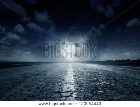 Night road against the background of cumulus clouds