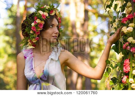 Beautiful woman in wreath of roses.