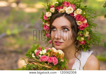 Attractive woman in wreath of flowers.