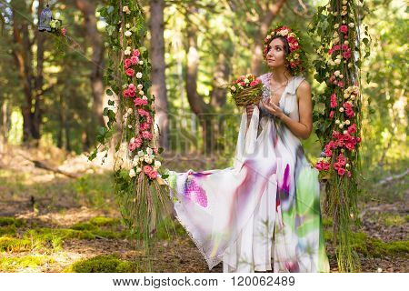 Attractive woman on flower swing.