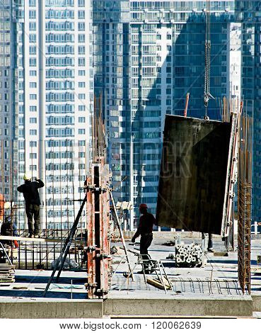 KIEV, UKRAINE - SEPT 12, 2015: Workers at work on a construction site