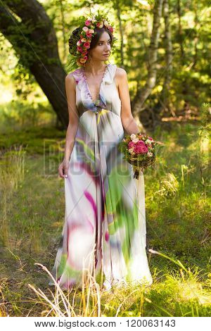 Attractive woman in wreath of flowers.