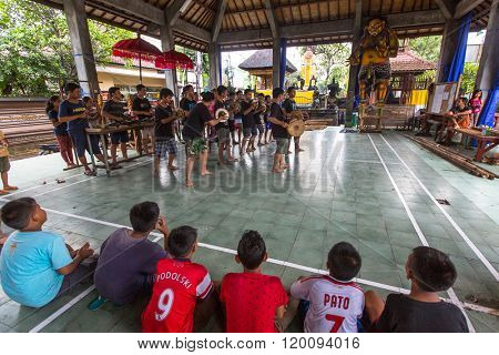 UBUD, BALI / INDONESIA - MAR 1, 2016: Unidentified teenagers at the time of preparations for Ngrupuk parade, which takes place on the eve of Nyepi day in Bali. Nyepi is a public holiday in Indonesia.