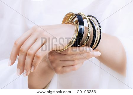 Girl's Hands With Golden Bracelets