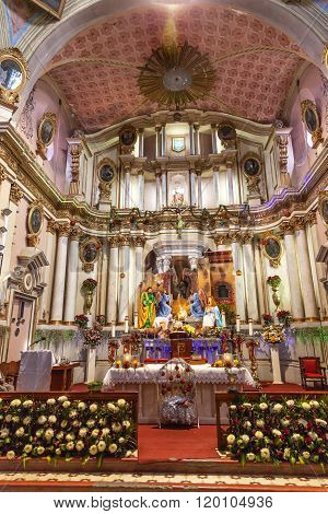 SAN MIGUEL DE ALLENDE, MEXICO - DECEMBER 27, 2014 Altar Crech Christmas Decorations Basilica Templo Del Oratorio De San Felipe Neri Church Facade San Miguel de Allende Mexico. Built in 1700s named for San Felipe Neri from Florence who founded Oratorio Cat