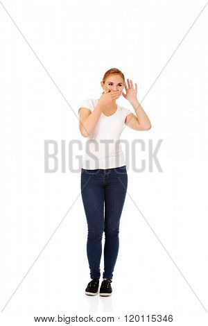 Young woman overhears conversation and giggles