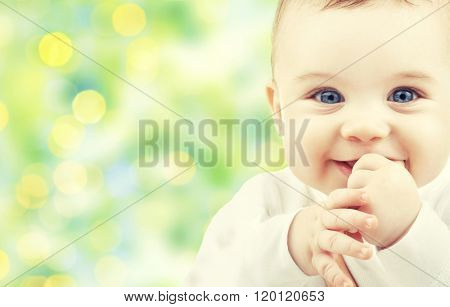 children, people, infancy and age concept - beautiful happy baby over green lights background