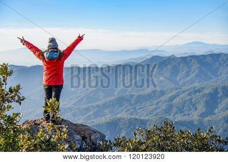 Woman Traveler On Peak Of Mountain