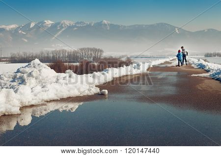 Two Little Boys Skate Together On The Asphalt Clear Out From Snow
