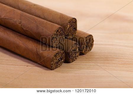 Different luxury cuban cigars on wooden table