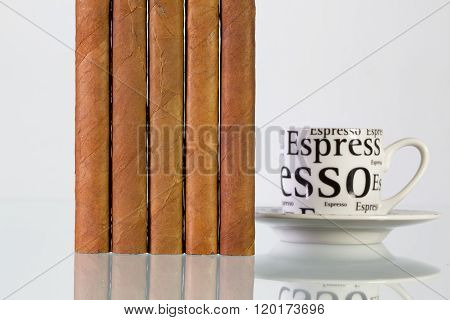 Different cigars and cup of coffee on a glass table and white background
