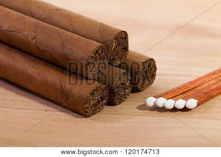 Different Cigars On Wooden Desk
