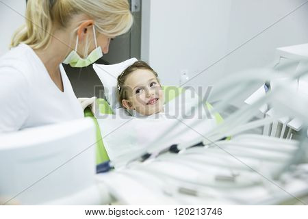 Little Patient Conversing With Her Dentist