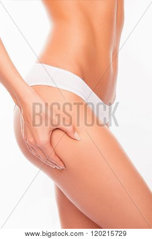 No To Cellulite! Young Sexy Woman In White Pants Touching Her Hip
