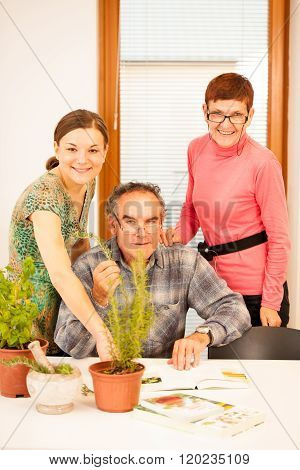 Workshop of knowing herbs touching and smelling basil and thym. Intergenerational transfer of knowledge.