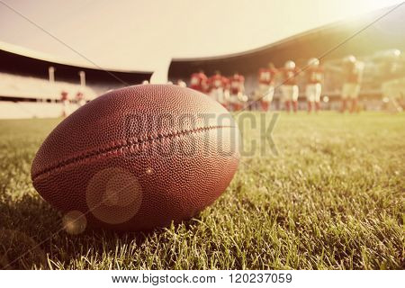 American football on the field, players in the background