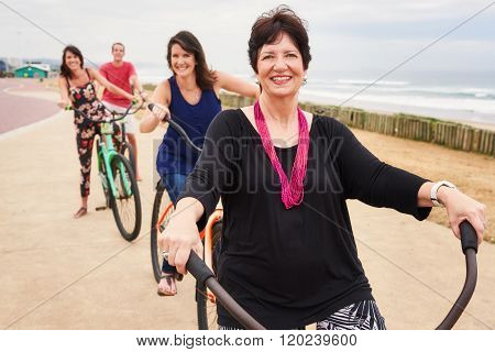Happy family and pround mother smiling on bicycles