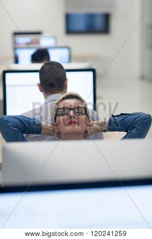 startup business, woman  working on dektop  computer at creative modern office relaxing and have fun