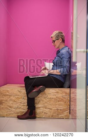 young woman in crative box working on laptop computer, startup business modern office room  interior