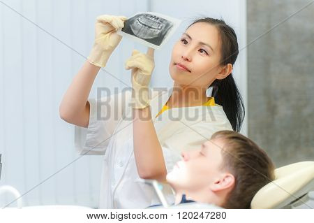 Dentist showing x-ray to a patient