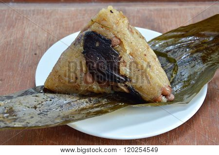 sticky rice steamed with pork and salt egg in banana leaf