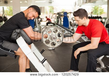 Male Friends Working Out At The Gym