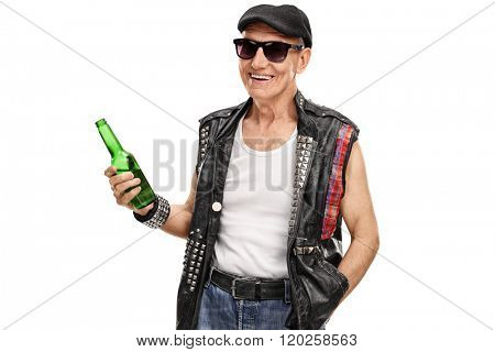 Senior punk rocker with a leather vest with pins holding a bottle of beer isolated on white background