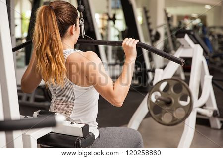 Strong Woman On A Lat Pulldown Machine