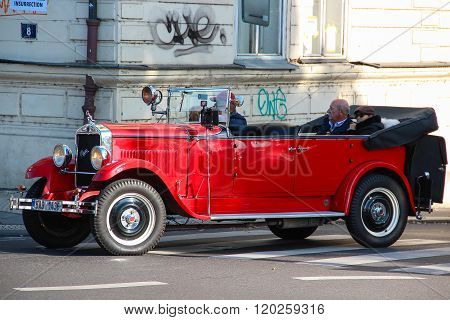 Red Praga car used for sightseeing tours in the streets of Prague.