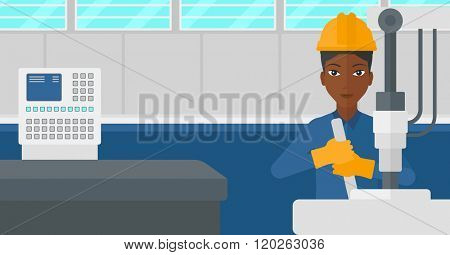 Woman working with industrial equipment.