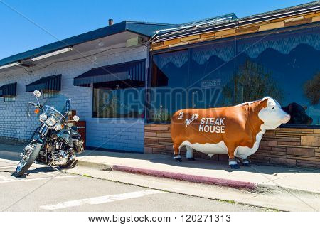 Williams, U.S.A. - May 25, 2011: Arizona, Route 66, a motorcycle in front of a steack house in the old town.