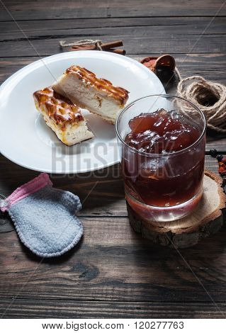 Berry drink. Kissel in glasses with cheese casserole and spices on wood