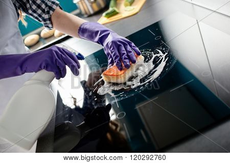 Woman's Hands Cleaning Kitchen Top In Protective Gloves