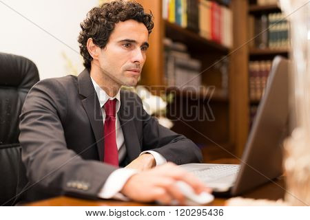 Businessman using a laptop in his office