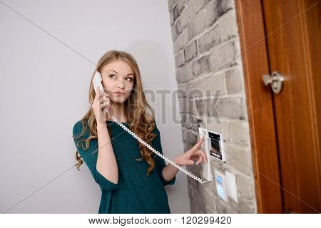 Blonde Woman Talking On The Intercom