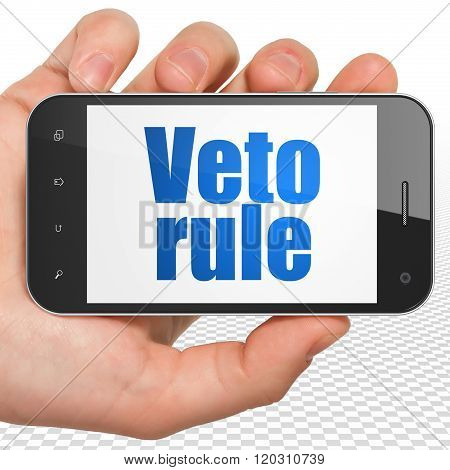 Political concept: Hand Holding Smartphone with Veto Rule on display