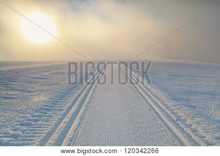 Ski Path On Snow At Sunrise