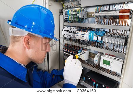 Male Electrician Examining Fusebox