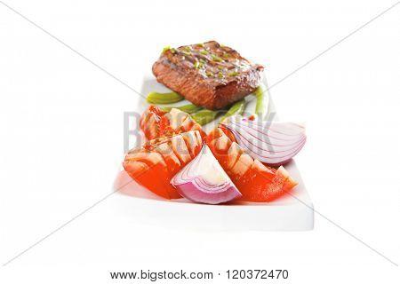 beef meat served with tomato on white porcelain