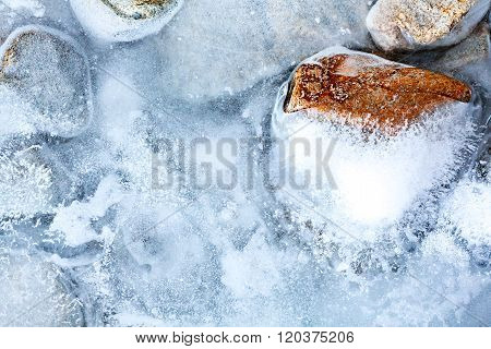 transparent ice with air bubbles and stones