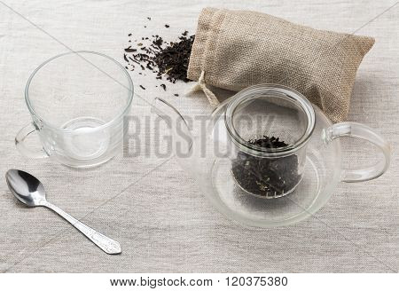 Set Glass Brewing Teapot, Teacup And Bag Of Black Tea