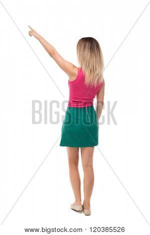 Back view of  pointing woman. beautiful girl. Rear view people collection.  backside view of person.  Isolated over white background. blonde in a green skirt and red sweater saw something interesting